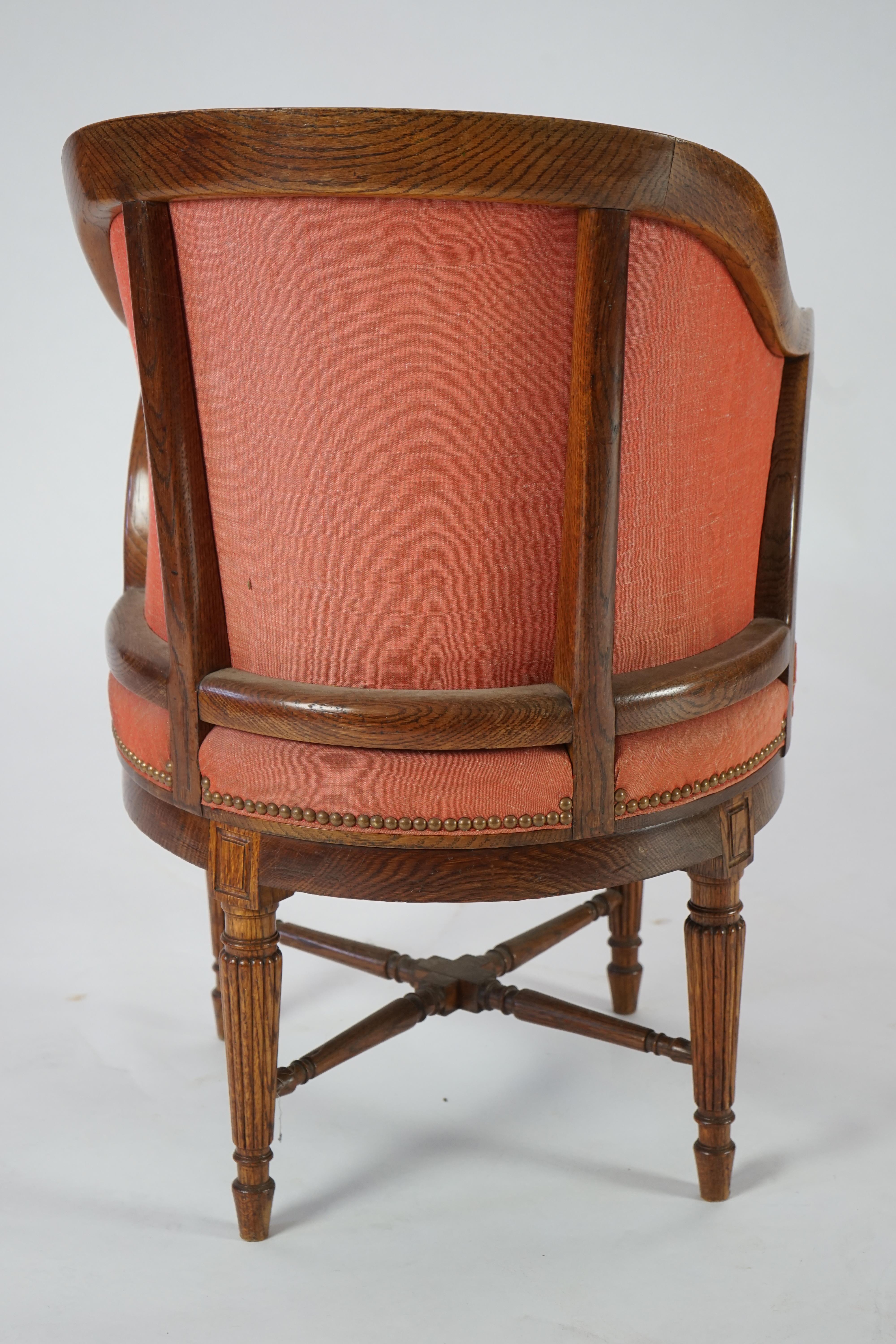 An unusual late Victorian oak revolving desk chair by Waring & Sons